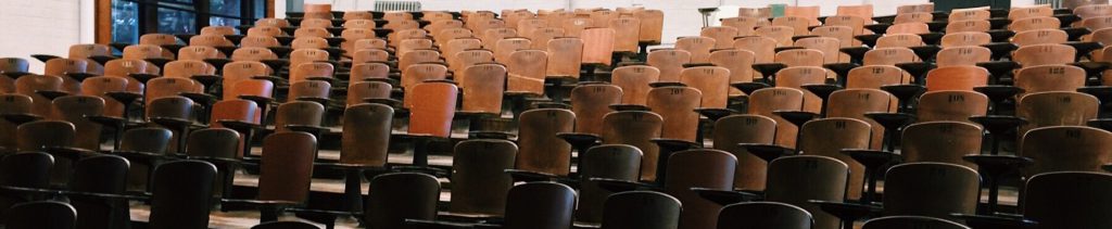 Desks in a classroom auditorium.